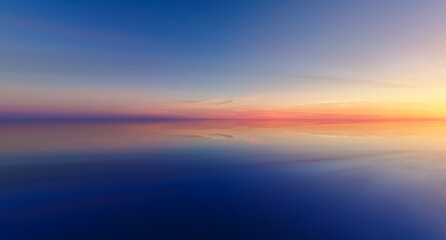 Tranquil Sunset Over Calm Ocean Reflections in a Cloudscape Gradient Sky at Dusk