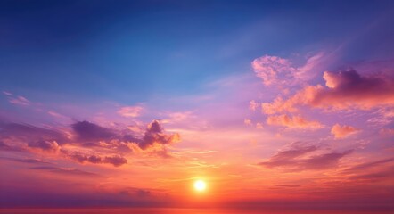 Beautiful sunset sky with vibrant orange and pink clouds as sun sets on horizon creating peaceful atmosphere