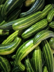Fresh striped cucumbers stacked together