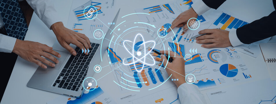 A business team working together to analyze data and trends using charts and a laptop, showcasing collaboration and modern workspace dynamics. Trope - Powered by Adobe