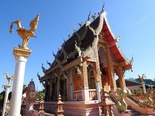 Ornate Golden Thai Buddhist Temple with Mythical Bird Statue