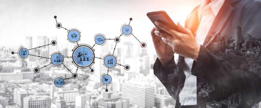 A businessman interacts with a smartphone while surrounded by digital network icons, symbolizing modern communication and connectivity in an urban setting. Tessel
