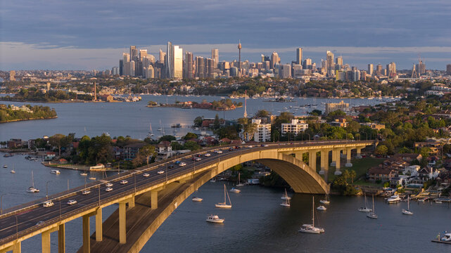 The Gladesville bridge over the Parramatta river with the city of Sydney in the background.