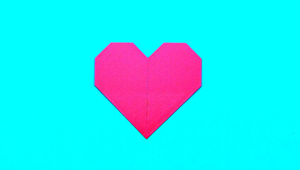 Fototapeta premium Geometric paper heart on a blue surface representing love