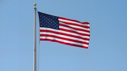 Fototapeta premium American Flag Waving Proudly Under Clear Sky