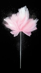 A delicate, abstract pink flower shape is depicted against a stark black background, adorned with shimmering, scattered particles.
