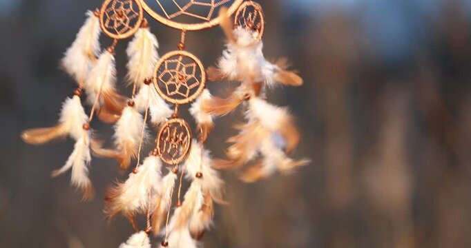 Shamanism. Beautiful dream catcher hanging outdoors, closeup