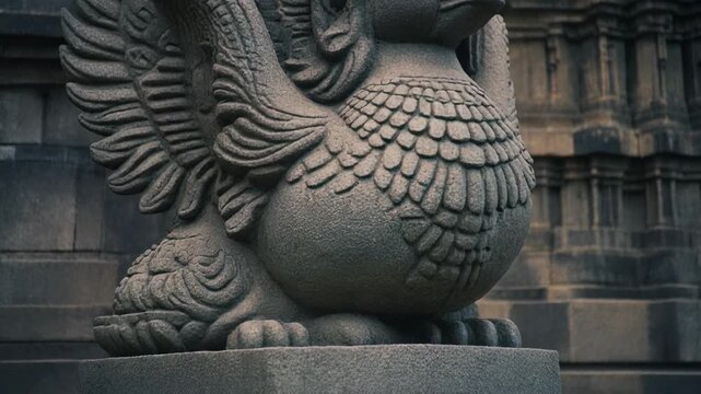 Ancient Stone Garuda Statue Adorning a Historic Temple in Southeast Asia.