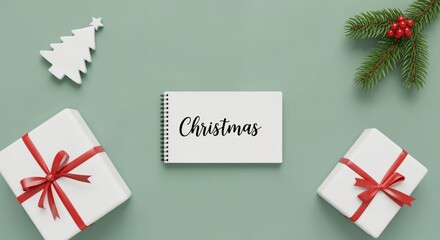 Christmas written on a notebook surrounded by festive holiday decorations, gift boxes, a pine branch, and a tree ornament on a light green background