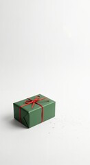 Minimalist green gift box with red ribbon on a clean white background, perfect for holidays and celebrations