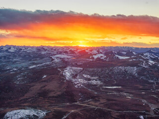 Fiery Sunset Over Snowy Plateau