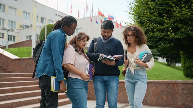 Diverse group of students discussing homework outdoors