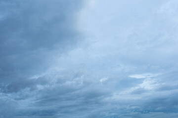 Overcast sky with dense layers of gray and light blue stratocumulus clouds overhead