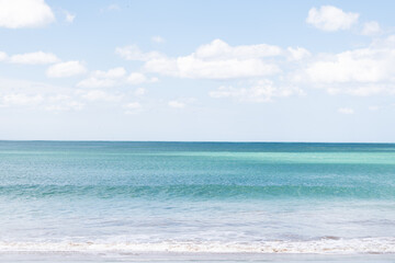 bright blue sea and blue sky with some clouds in the background