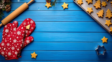 Preparing festive homemade Christmas cookies with baking tools on a rustic blue wooden background for the holidays