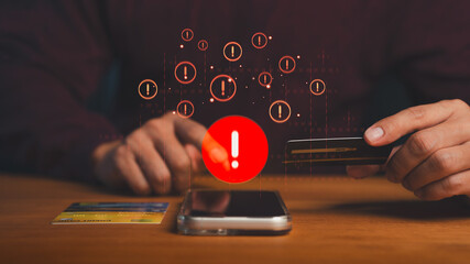 Person using credit card and smartphone with warning alert symbol highlight online payment risk, cybersecurity threat, online shopping, fraud prevention, data protection, secure digital transactions.
