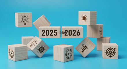 Wooden blocks with 2025 and 2026 numbers and an arrow, surrounded by various business icons, representing new year planning, strategic goals, future vision, and business development
