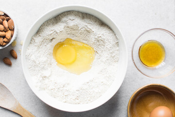 overhead view of almond biscotti dough being mixed in a white bowl, flatlay of biscotti cookie dough or twice baked cookie dough