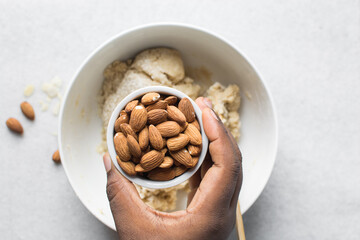 overhead view of almond biscotti dough being mixed in a white bowl, flatlay of biscotti cookie dough or twice baked cookie dough