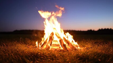 Vibrant campfire crackles with bright flames, evoking cozy comfort and outdoor adventure bonfire glowing with warmth and joy twilight, darkening sky