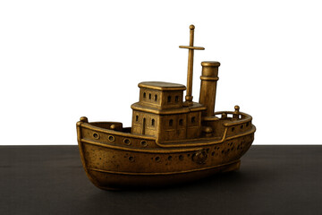 Fototapeta premium Miniature brass tugboat model with intricate detailing, showcasing a classic design and steamship aesthetic on a dark surface