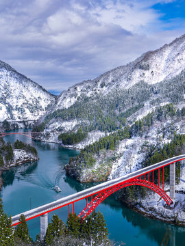 Red Bridge and Tour Boat Ripples in the Snowy Shogawa Gorge, Nanto City Toyama