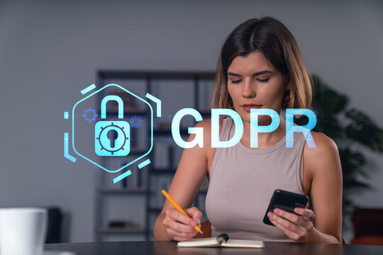 Smiling businesswoman in casual wear holding using smartphone typing at office workplace with notebook. Concept of distant work, business education. Data security hologram