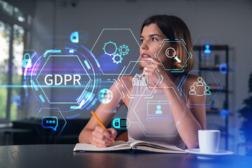 Smiling woman in casual wear taking notes in notebook at office workplace with coffee cup. Concept of distant business education, information technology, dreaming, thinking. data security drawings