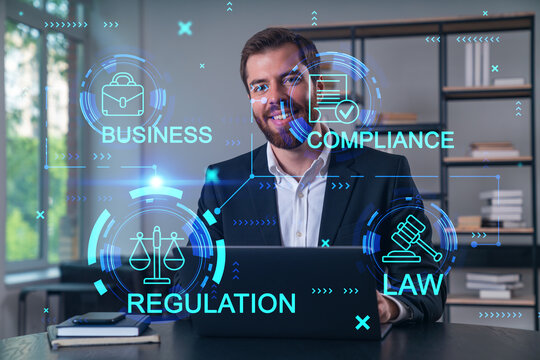 Smiling businessman in formal wear working on laptop at office workplace with smartphone and notebooks. Concept of successful business deal, agreement. Legal and law icons.