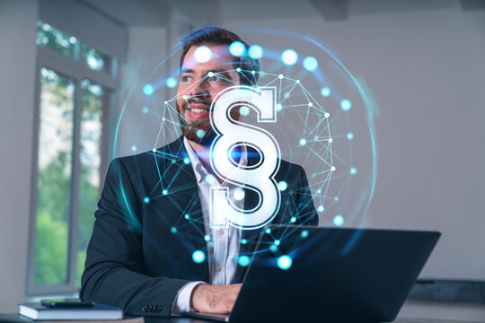 Smiling businessman in formal wear working on laptop at office workplace with smartphone and notebooks. Concept of successful business deal, agreement. Legal and law icons.