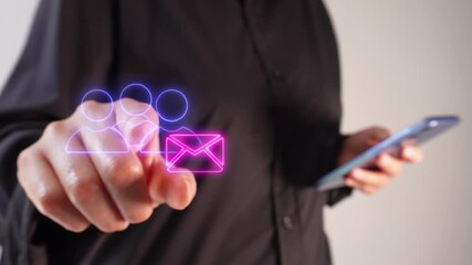 Connection and communication between people via email. A businesswoman holding a smartphone while pointing forward at a virtual icon of a group of people with a virtual mail envelope. - Powered by Adobe