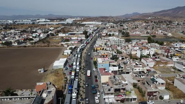 Heavy traffic on Emiliano Zapata avenue, multiple trailers trying to enter the Silao bypass. Silao, Guanajuato, Mexico