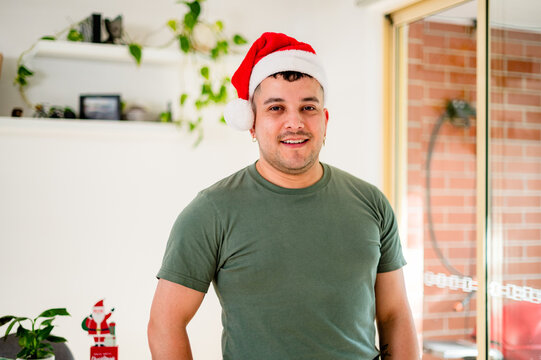 A man in a Santa hat enjoys the holiday spirit with Christmas decoration