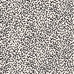Abstract pattern of black, curved, and angular shapes scattered across a light background, creating a playful and retro aesthetic ideal for graphic design and textile applications