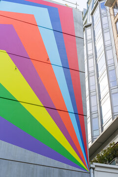 Tightly cropped view of a colourful geometric pattern on ther side of a city building