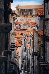 Scenic Dubrovnik old town rooftops view from narrow medieval alley historic Croatia cityscape terracotta tiles stone houses travel photography European coastal city UNESCO heritage destination