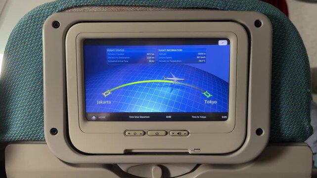 flight route on the in-flight entertainment screen in economy class seat on a long flight to Japan from Indonesia. Garuda Indonesia airplane interior