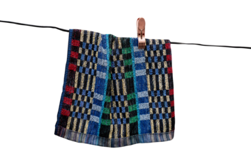 Colorful checkered cloth hanging on a clothesline.