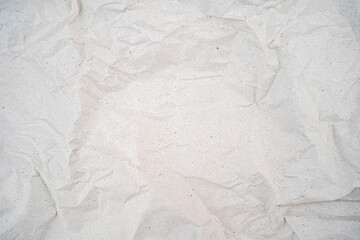 Crumpled white paper texture with visible folds and creases.