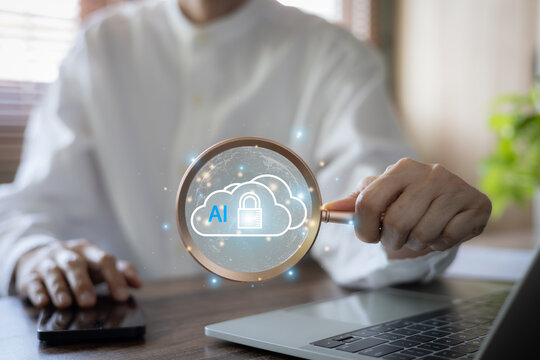 Businessman holding magnifying glass focused on AI cloud security padlock icon. Concept of cloud computing protection, artificial intelligence data safety, and secure network storage inspection.