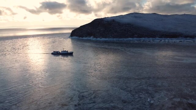 Boat float in frozen winter water landscape among ice shore. Boat Explore Climate Change in Polar Nature Melting Ice Water Top Drone View Footage.