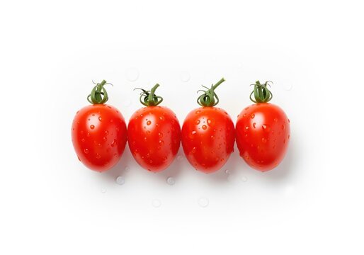 Neatly arranged row of four fresh, bright red grape tomatoes with water droplets