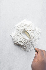 overhead view of All purpose flour on a countertop, top view of baking flour on white countertop