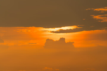 Beautiful golden sunset sky with dramatic clouds and vibrant orange tones creating a warm and peaceful evening atmosphere