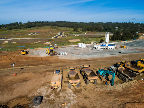 Machinery parked on Singleton Bypass worksite with view to new housing area with land for sale 