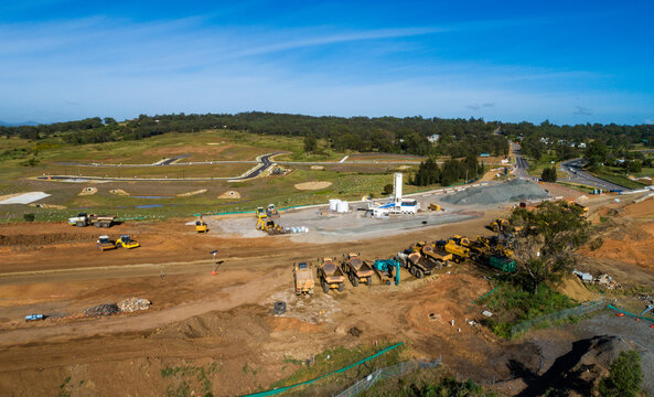 Machinery parked on Singleton Bypass worksite with view to new housing area with land for sale 