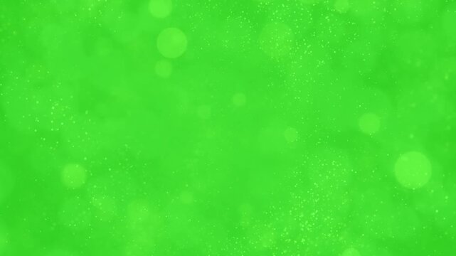 Soft Golden Bokeh Circles and Fine Particles Floating Slowly on a Green Screen Chroma Key Overlay.