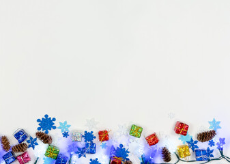 Christmas decorations with snowflakes pinecones and gift boxes on white background