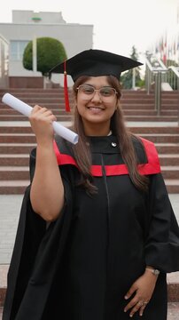 Proud Indian graduate student celebrating commencement day with diploma