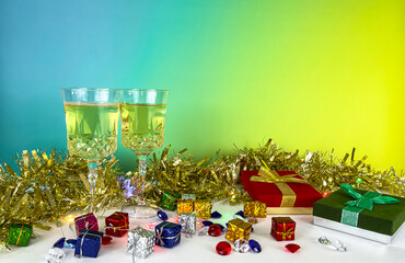 Holiday celebration with champagne glasses gift boxes and golden tinsel decorations